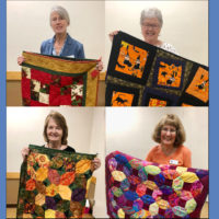 Winners of quilt fundraiser with quilts