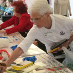 Volunteer Assisting Residents with Bingo cards