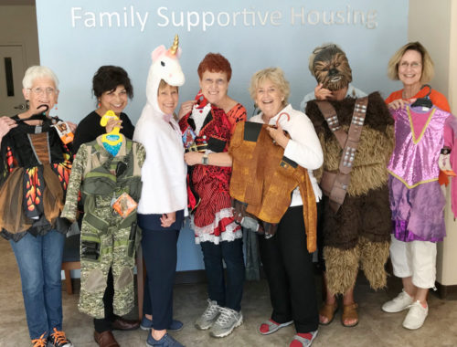 Halloween store at Family Supportive Housing - volunteers with costumes