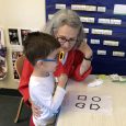 Screening Eyes Early volunteer working with child