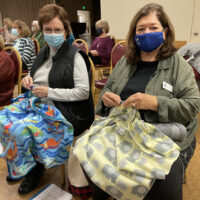 Members crocheting blankets at a Regular Meeting