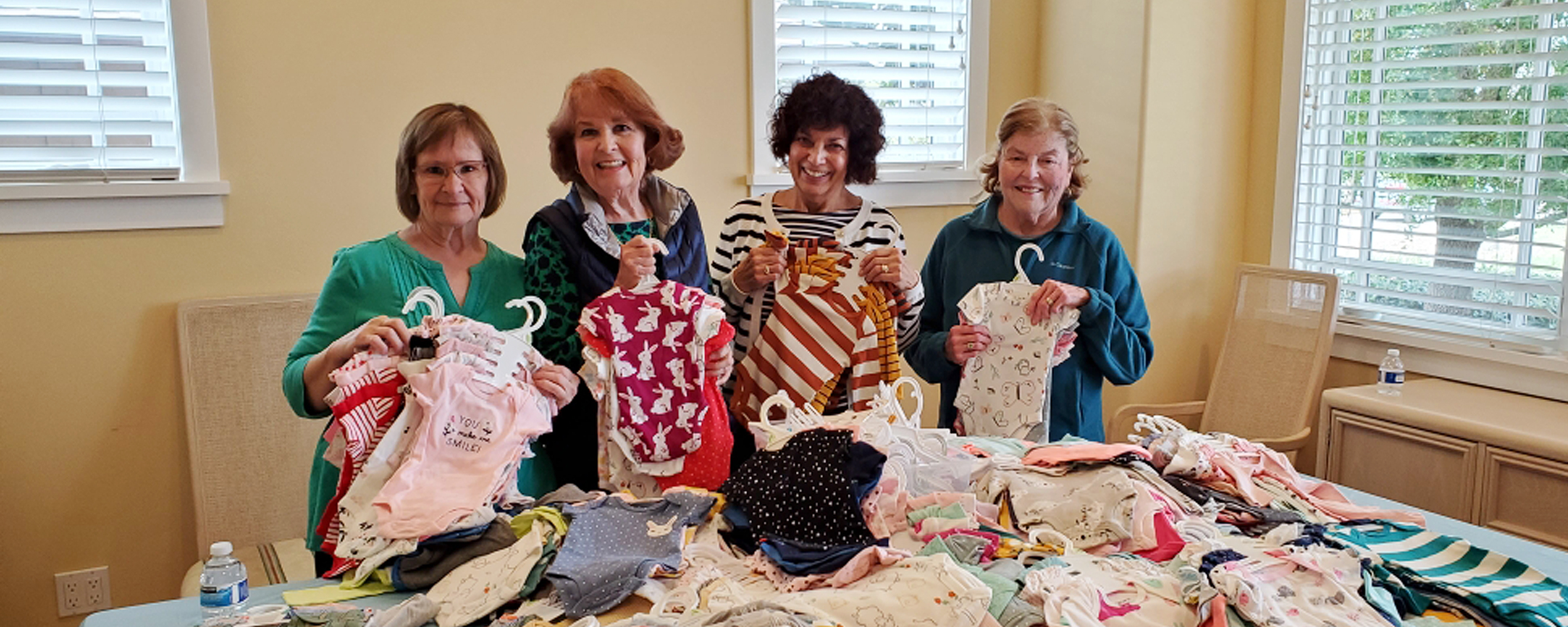 Sorting Onesies from Baby Shower