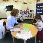 Volunteer working with preschooler