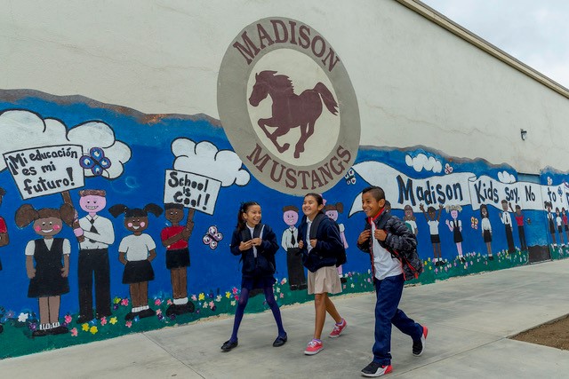 kids on front of mural