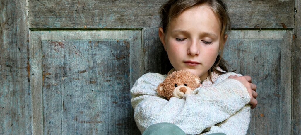 Sad little girl with teddy bear