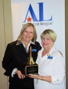 National Operation School Bell award presented to Chris Schroeder Fain (L) by Joan Craig (R) , at Assistance League of Bend's Annual meeting on May 5th, 2015