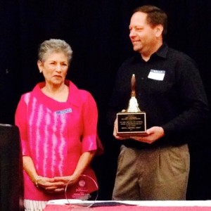 Curt Goldgrabe, Executive Director of John F. Nagel Foundation, after receiving the Operation School Bell Award from Marianne Spiegel, Grants Chairman.