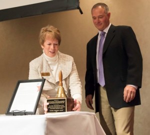 Mary King, one of Assistance League® of Greater Cincinnati's Operation School Bell® team leaders, about to present the award to Scott Lovdal, President and Owner of Industrial Environments.