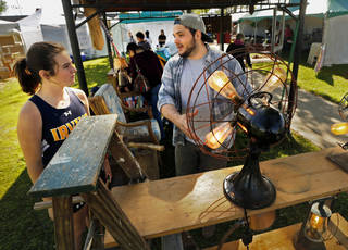 Artist Aaron Paul describes his work to MyKenzi Miles during the May Fair at Andrews Park on Saturday, April 30, 2016 in Norman, Okla. Photo by Steve Sisney, The Oklahoman