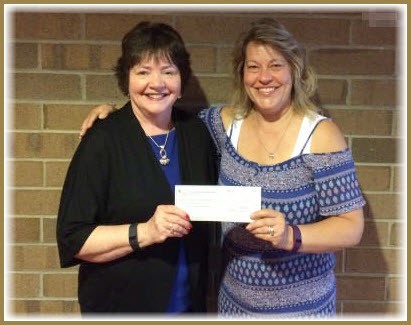 Sue Evans (right) from the HUGS group at St. Paul's United Methodist Church in Rochester presents a $400 check to Camille Doerr (left) of Assistance League of Southeastern Michigan. This donation will provide warm winter coats, clothing and necessities to five children in need through Assistance League's Operation School Bell program.