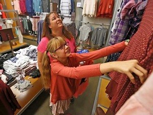 Jenna Root, 11, looks at a dress with her mom, Jennifer, while shopping at Old Navy in Stevenson Ranch during the Assistance League's Operation School Bell on Tuesday. Katharine Lotze/The Signal