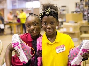 These two young ladies are thrilled with the shoes they received through Operation School Bell and Shoe Carnival. (Photo: Susie Moore Photography)