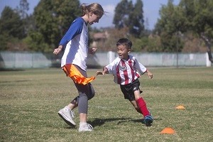 Six-year-old Jaden Panaguiton, right, tries to grab Ariana Powell's jersey during practice in Tustin on Sunday, October 2, 2016. (Drew A. Kelley, Contributing Photographer)