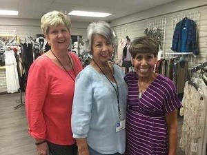 Paula Carter, left, Sandi Reed and Marie Garcia are Assistance League of the Foothill Commuities volunteers and were at the recent thrift store re-opening. (Photo by Suzanne Sproul) 