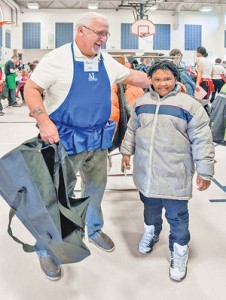 Reggie Zalewski of Macomb with 3rd grader Anton Harris who had just selected a new jacket for himself.