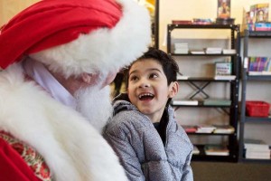 THE TIMES: JAIME VALDEZ - Romeo Islas, 8, of Beaverton is wowed by Santa on Saturday.