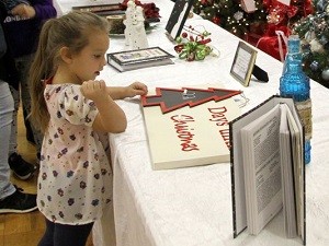 A child looks at Christmas decorations at the Assistance League's Christmas Bazaar.