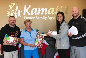 Kamali’i Foster Family Agency staff accepts Christmas presents from Assistance League of Temecula Valley. Kamali’i Program Director J. Eric Mortensen, Chairperson of Operation Foster Youth Wendy Bradshaw, Lorna Mortensen and Lee Burton receive gifts to be given to local foster youth for Christmas.