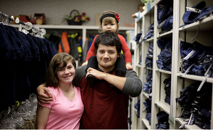 Justin LeMoine, his wife, Lora, and his daughter, Kayleanne, deliver donations Thursday at the Assistance League of Tulsa, where Justin received clothes as a foster child. MIKE SIMONS/Tulsa World