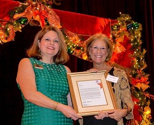 Kathy Young presenting National President Anita Friesen's congratulatory letter to Operation School Bell Award recipient Peggy Hays.