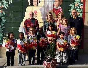 Assistance League coloring contest winners are, front row, from left, Delilah Garcia, Joshua Mkanza, Samara Ruddle, Elisha Mkanza, Alaxandria Morales, Marcia Sotero, Mayghen Grome (in back) and Madalynn Covington. In back are, from left, Larry Dierdorff, Christine Coates, Lynn Reiter and Paul Foster. Larry Dierdorff’s Assistance League mural is behind them. Courtesy Photo