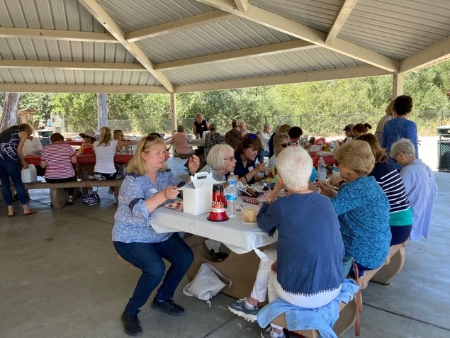 wOMEN SITTING AT TABLE EATING LUNCH