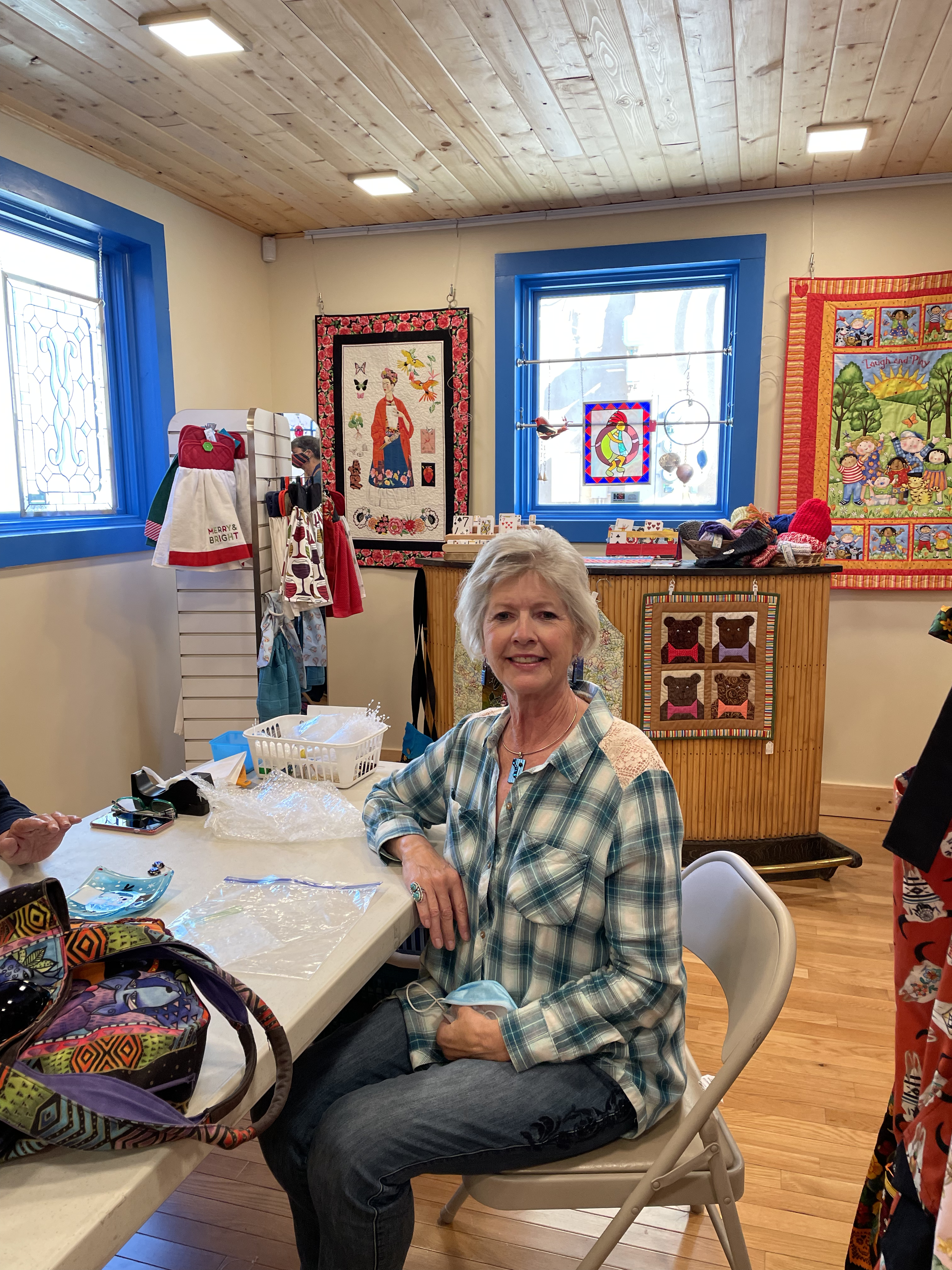 Assistance League Blue Portal gift shop - Albuquerque (1) woman sitting at a table