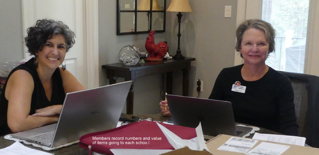 Women sitting at a table with laptops